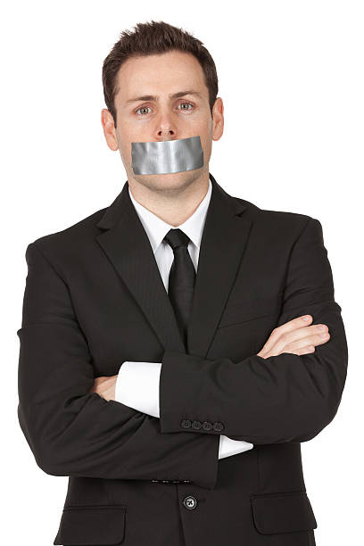 Businessman with duct tape on his mouth Businessman with duct tape on his mouth speak no evil stock pictures, royalty-free photos & images