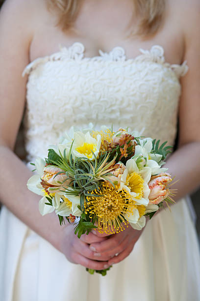 Bride holding springtime floral bouquet stock photo