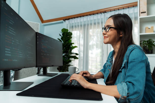 istock Young Asian in IT creating with typing online information on pc. Stratagem. 1852282708
