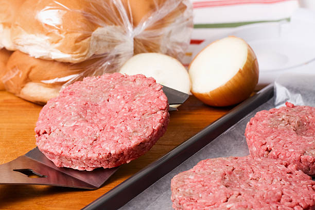 istock Raw Burger on Spatula with Onions and Buns 185228385
