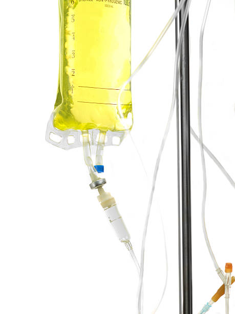 istock Close up of yellow IV drip against white background 185228637