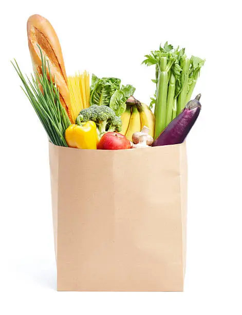paper bag full of groceries isolated on white