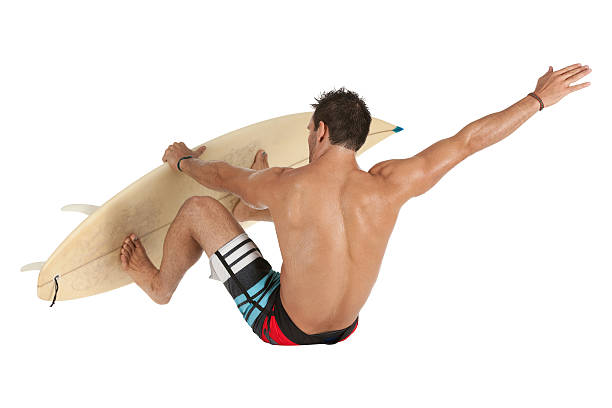 мужской серфер в действии - swimming shorts surfing male full length стоковые фото и изображения