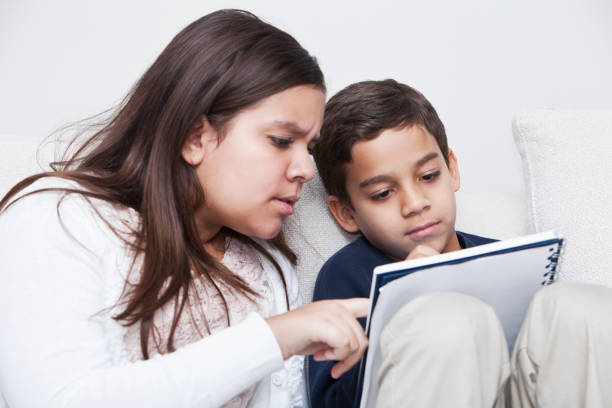 istock Big sister helping little brother with homework 185229756