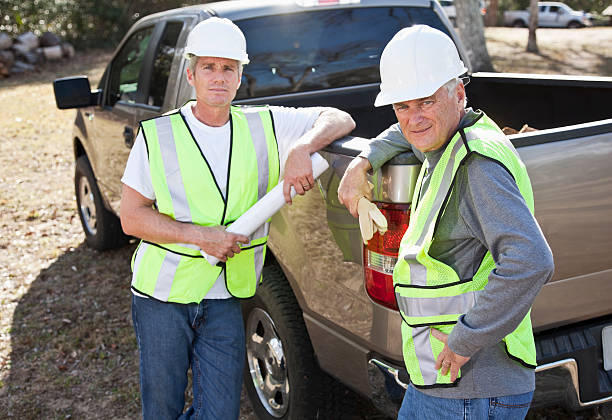 istock Manual workers wearing hardhat and safety vest 185229787