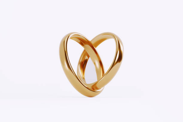 istock Gold Wedding Rings Forming A Heart Shape On White Background 1852298835