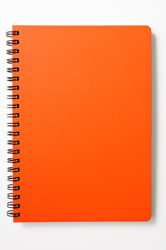 With CLIPPING PATH.Red spiral notebook isolated on white background with clipping path.Studio shot.