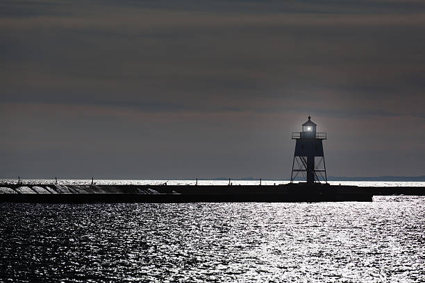 istock Harbor Lighthouse with Guiding Light in Dark and Stormy Night 185230363