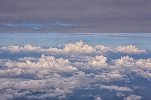 Blue Skyline View above clouds from plane in sunny day