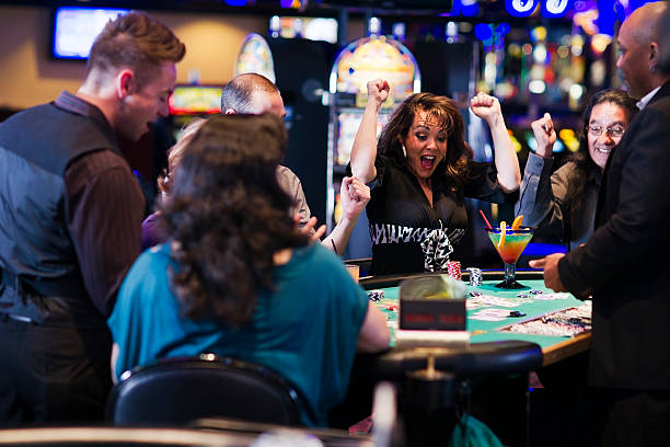 A group of people playing blackjack at a casino  stock photo