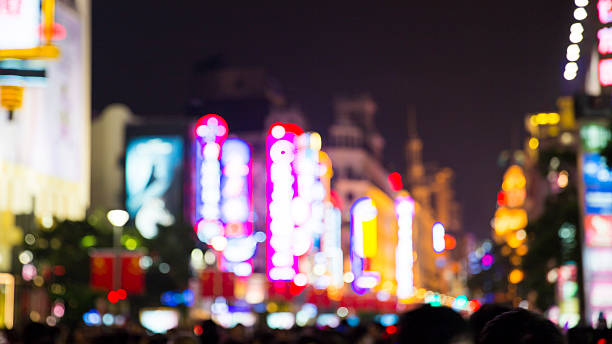 istock Defocused Crowded Street at Night 185231001