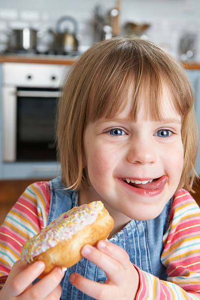 istock Young Girl Enjoying Sticky Doughnut 185231003