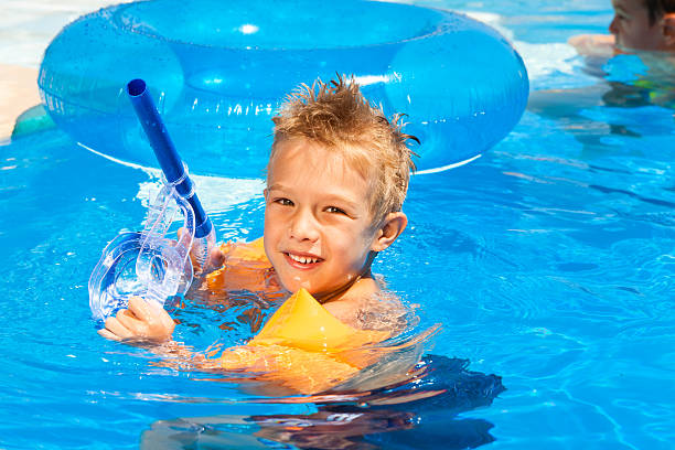 istock Child with water wings relaxing the swimming pool 185231255