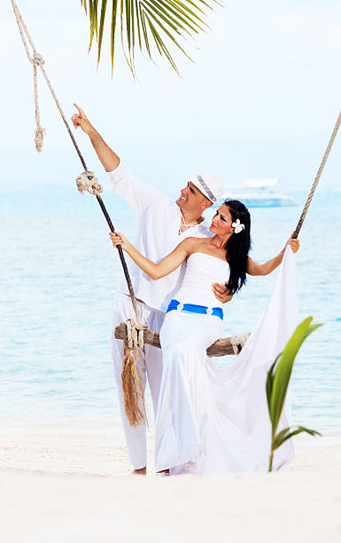 istock Married couple on swing at the beach 185231295