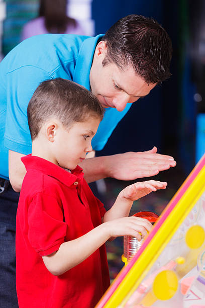 istock Father and Son in an Amusement Arcade 185231517