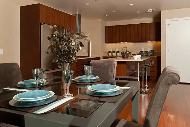 Great room style dining room and kitchen. Table set for four.