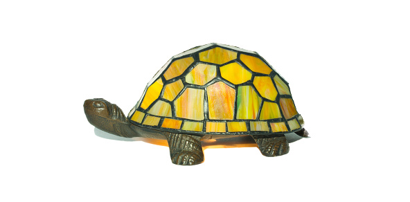 Tiffany style vintage lamp turtle tortoise design with attached art deco stained glass in green, yellow, red colors. Bronze brass head and legs. Isolated on white background.