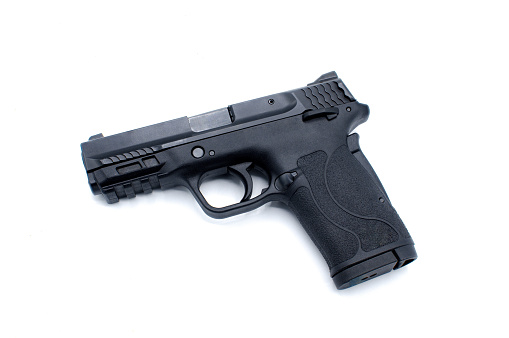 380 auto semi automatic handgun pistol Black metal with hard polymer grip 8 round semi automatic clip magazine ammo ammunition. Self defense weapon isolated on white background