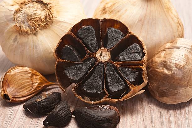 Close-up of caramelized flesh of black garlic Fermented Black Garlic garlic stock pictures, royalty-free photos & images