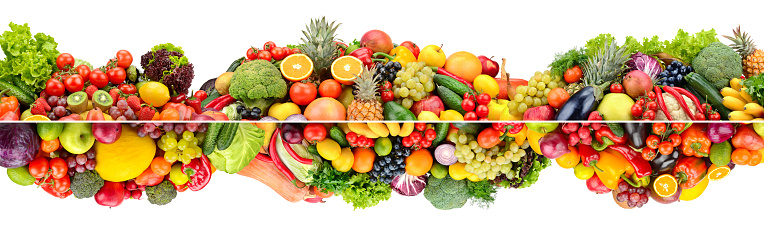 Wide composition of multi-colored fruits, vegetables and berries isolated on white background.