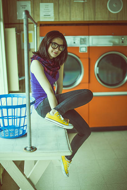 istock Young woman in a laundromat 185232499