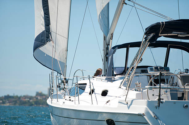 Yacht shot from the water with sales billowing. Sydney Harbour
