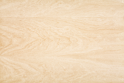 Overhead view of light colored wooden floor. This background features a distinguished wood grain pattern complete with heavy swirls, wavy lines.