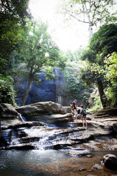 istock Young Man and Woman Hiking a Tropical River 185233189