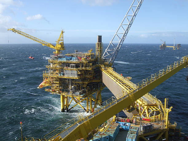 Production Platform Complex A group of offshore oilrig production platforms on a blustery dayMore oilfield images: north sea oil and gas stock pictures, royalty-free photos & images