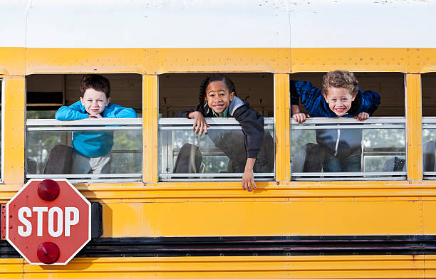 istock Children looking out school bus window 185233698