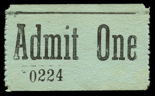 vintage admission ticket stub against black