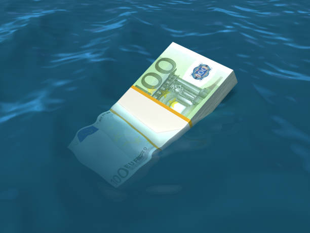 istock Money sinking in water. Euro notes. 185233894