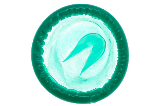 condón retroiluminado verde - condom sex sexually transmitted disease aids fotografías e imágenes de stock