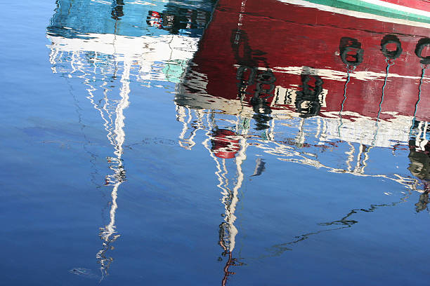 istock Reflections of boats in water 185234033