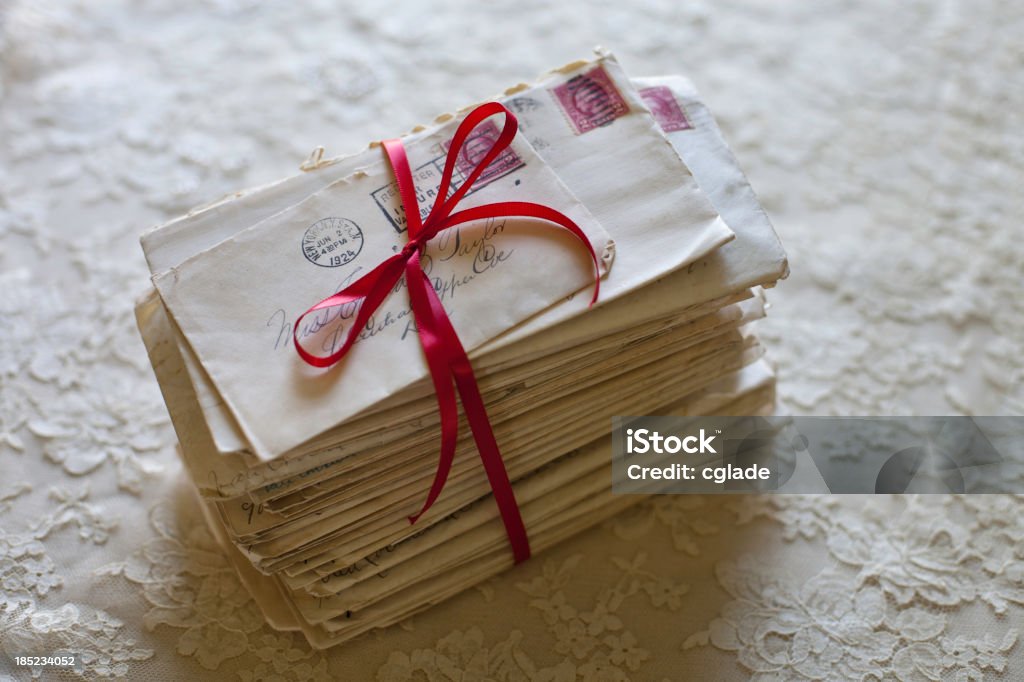 Love Letters Stack of old letters tied in red ribbon Letter - Document Stock Photo