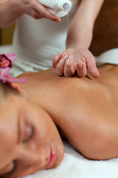 istock Therapiest pouring massage oil 185234056