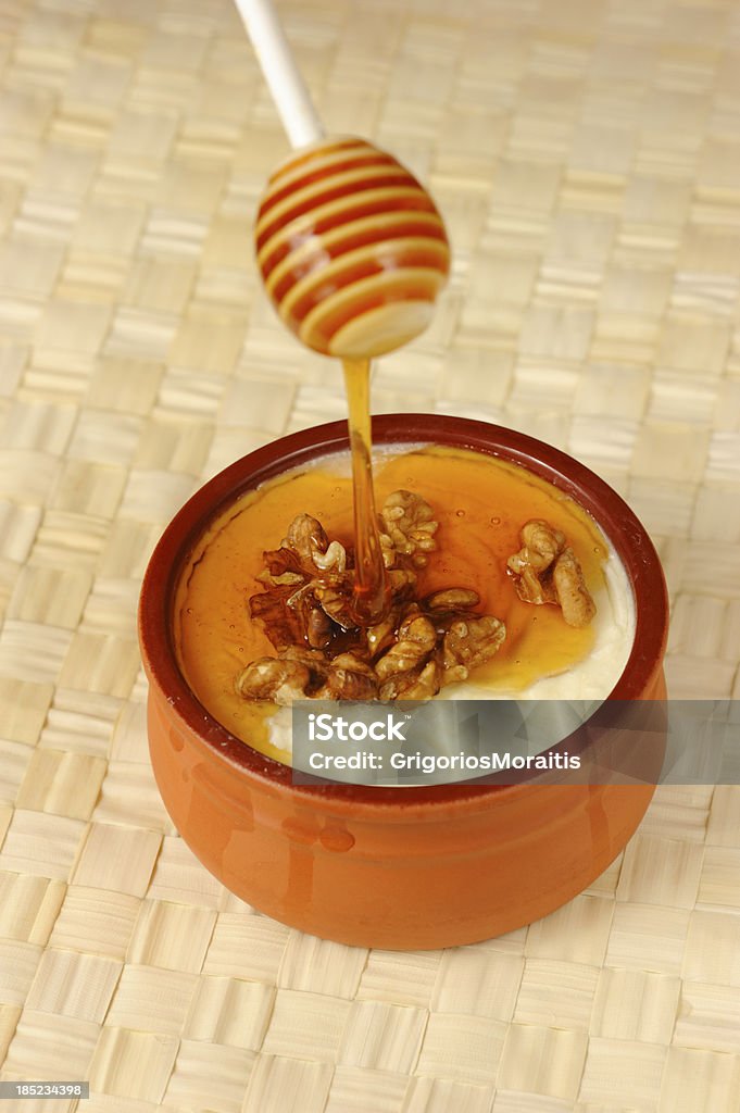 Honey and Walnuts on Yogurt Small farm greek yogurt served with honey and walnuts.related images Honey Stock Photo