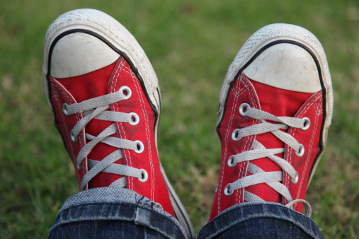 Red shoes and jeans with grass background