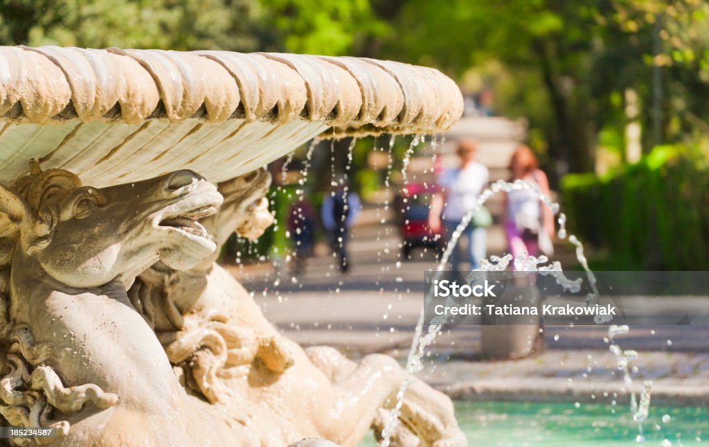 Beautiful day in the park (Rome, Italy) Old (Baroque Style) fountain in the Roman park. In the background park alley with walking people.See also: Fountain Stock Photo