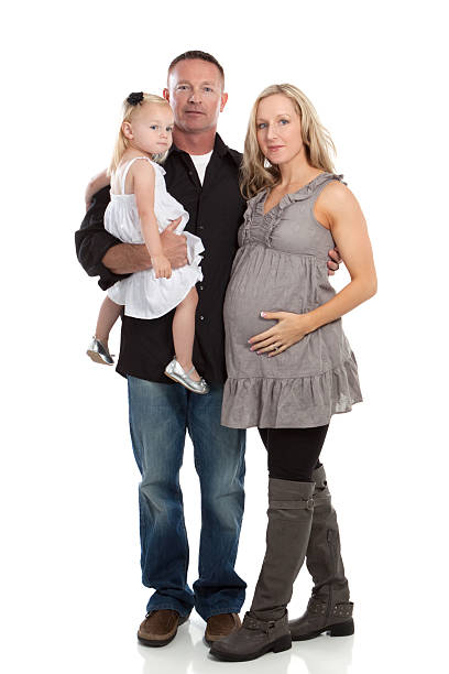 portrait of a pregnant woman with her husband and daughter - pregnant isolated on white stockfoto's en -beelden