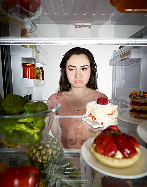 istock Woman Looking at Broccoli 185234701