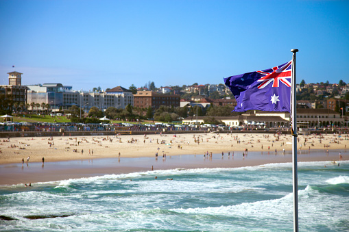 Austalian flag in foreground at Bondi.