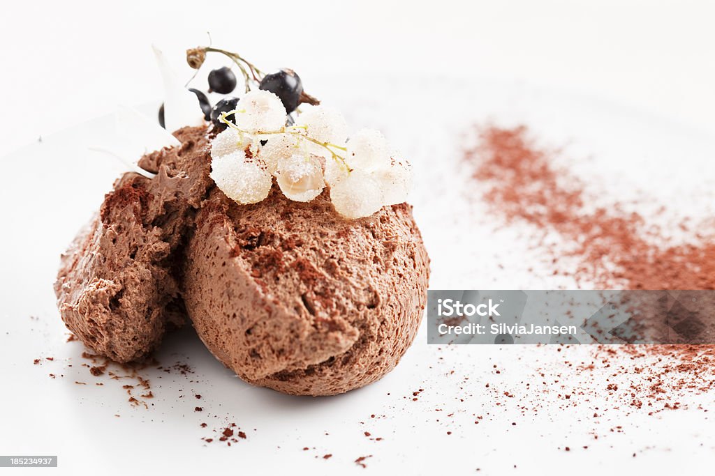 chocolate mousse dessert "chocolate mousse dessert on a plate with garnish of blach and white currant, white currant covered with sugar, cocoa powder used for decorationhere you can see more" Chocolate Mousse Stock Photo