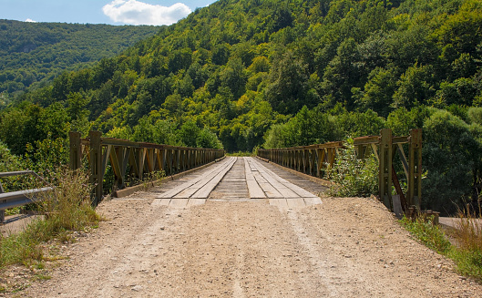 A wooden bridge crossing the River Una in Martin Brod in the Una National Park. Una-Sana Canton, Federation of Bosnia and Herzegovina. Early September