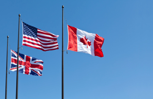 USA and Canada flags waving in the wind free exchange north america currency clear sky national patriotism