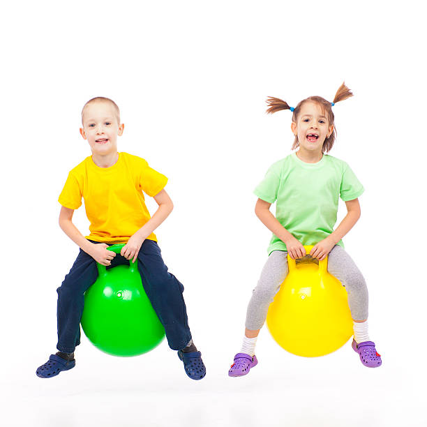 istock brother and sister heaving fun with bouncing ball 185235150