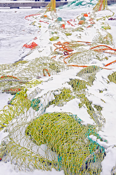 istock Fishing nets in snow on commericial docks 185235318