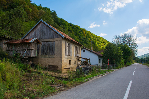 Houses on a country road just north of Martin Brod, Bihac, in the Una National Park. Una-Sana Canton, Federation of Bosnia and Herzegovina. Early September