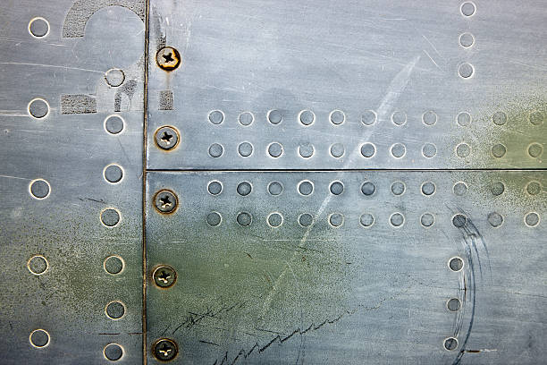 Metal XXXL Background With Rivets and Screws airplane metal texture with screws and rivets classic metal stock pictures, royalty-free photos & images
