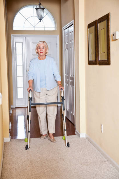 istock Senior woman at home using walker 185235720